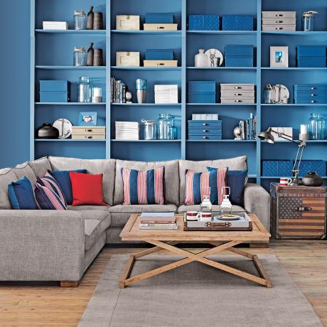 Sala de estar inspirada no litoral com estantes em negrito azul