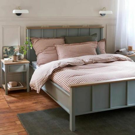 Cadre de lit en bois gris dans une chambre neutre