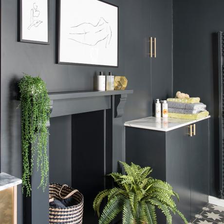 Black-bathroom-makeover-with-patterned-floor-tiles-plants-and-roll-top-bath-3