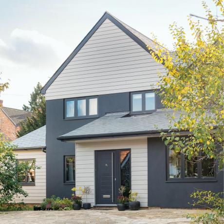 экстерьер дома с серыми окрашенными стенами и деревянной облицовкой современного семейного дома