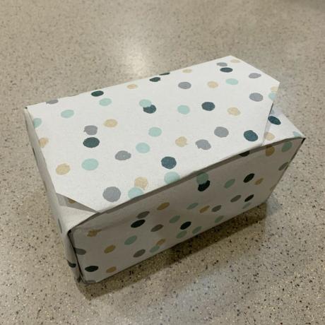 Image d'un cadeau emballé dans du papier cadeau à pois neutres