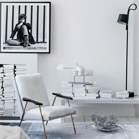 Hvit stue med svart-hvitt trykk og elegante sitteplasser