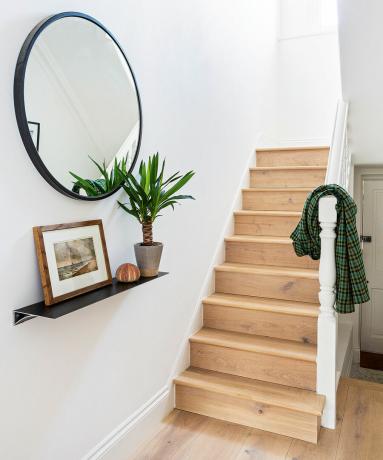 Escada com espelho redondo e saliência para quadros