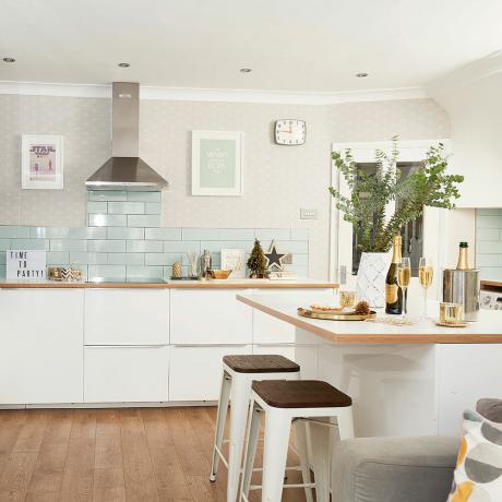 Open-plan-kitchen-with-white-gloss-units-and-Scandi-geometric-wallpaper-6