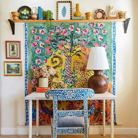 Rašomojo stalo zona su dekoruota kėde ir pakabinama ant sienos už rašomojo stalo