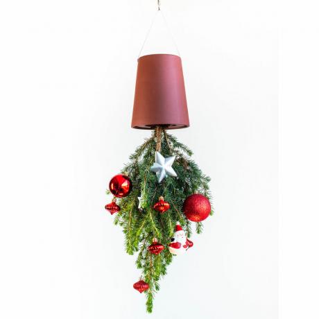 La maceta invertida gira la decoración navideña en su cabeza