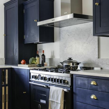plinski štedilnik v modri kuhinji z jekleno napo