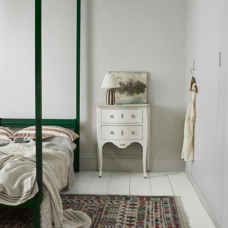 작은 침실 색상 아이디어, 흰색 마루판이 있는 매우 옅은 회색 침실, 흰색 빈티지 사이드 테이블, 예술 작품, 녹색 페인트 4주식 침대, 빈티지 러그