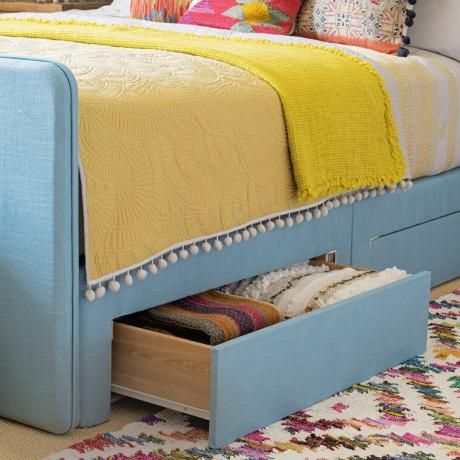 tempat tidur dipan berlapis kain biru dengan laci tersembunyi di bagian dasar untuk penyimpanan tambahan