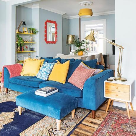 otvorená obývacia izba s modrou zamatovou pohovkou