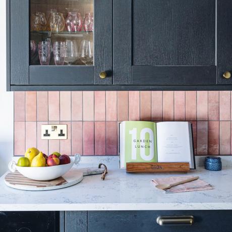 Κουζίνα με ροζ πλακάκι splashback και σκούρο γκρι ντουλάπι
